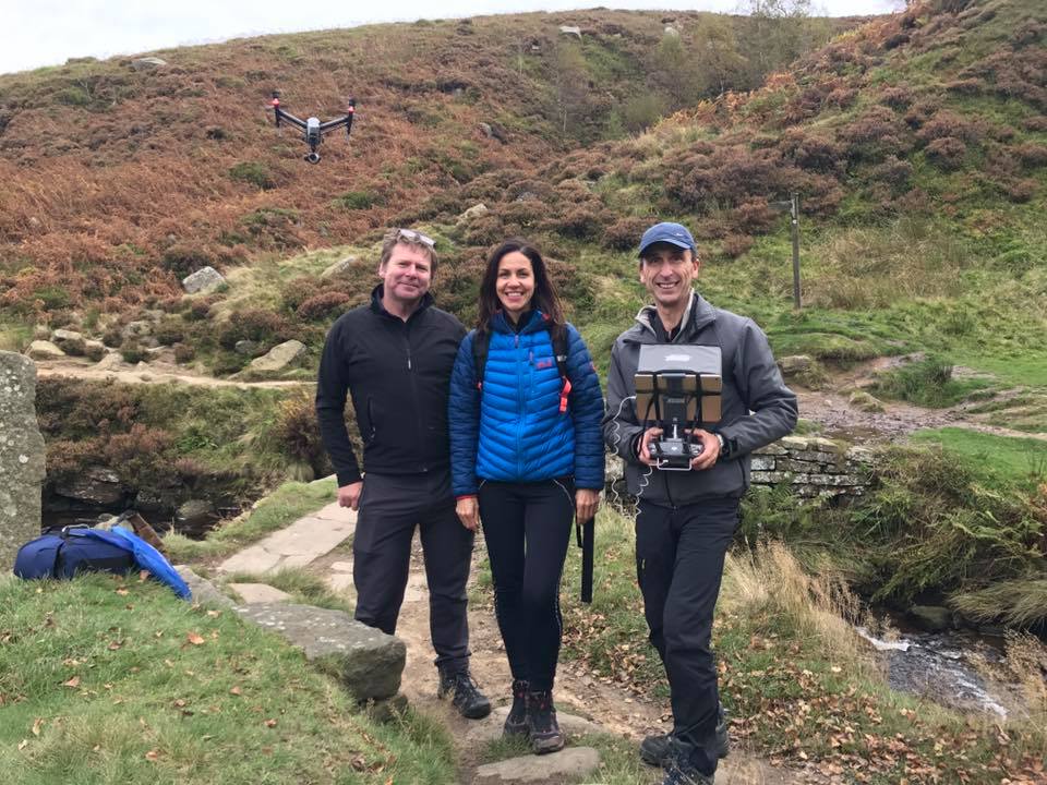 Phil Fearnley with two crew on moorland, a drone hovering overhead
