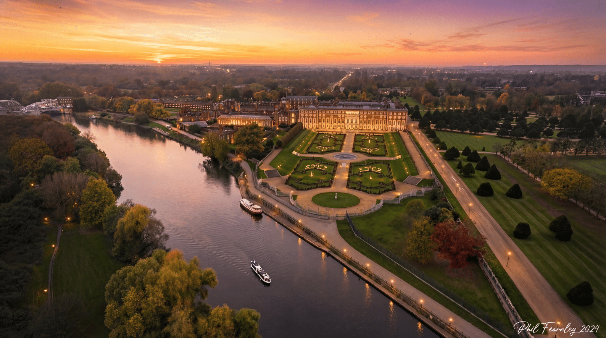 Hampton Court Palace beside the Thames at sunset, from the air